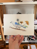 Oiseau blanc et bleu avec des pissenlits 
